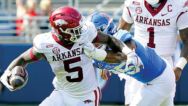 Arkansas Razorbacks running back Raheim Sanders (5) is grabbed from behind by Mississippi Rebels defensive lineman Tavius Robinson (95) at Vaught-Hemingway Stadium.